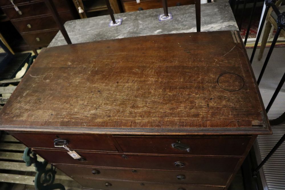 A George III oak chest of three long and two short drawers, width 104cm, depth 53cm, height 106cm